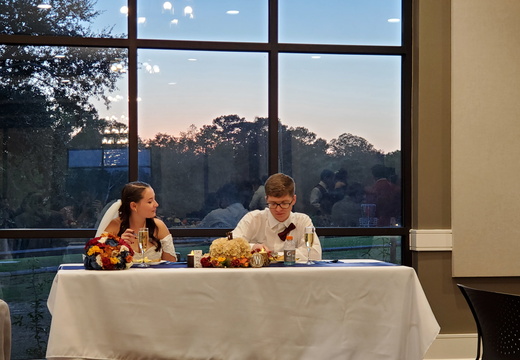 The couple enjoying dinner at the head table